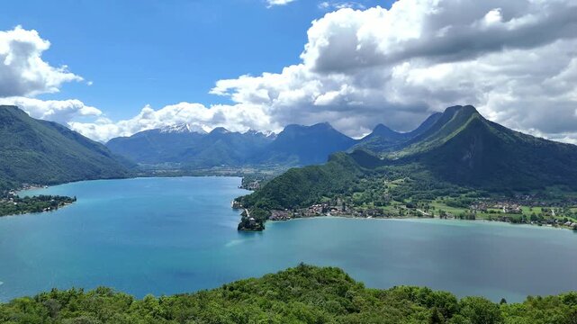 Scenic aerial view of Lac d'Annecy and Duingt Castle, French Alps, Haute-Savoie, France, Europe. Breathtaking panorama of the French Alps surrounding the turquoise waters of Lac d'Annecy, France, Euro