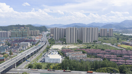 Modern residential district with elevated highway and mountain backdrop © TranThi