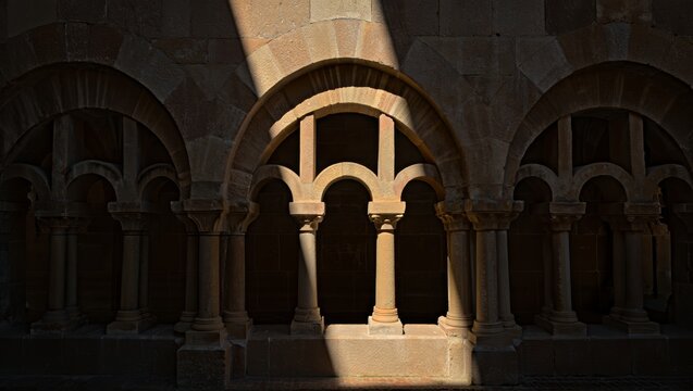 Ancient Romanesque Arches with Dramatic Sunlight