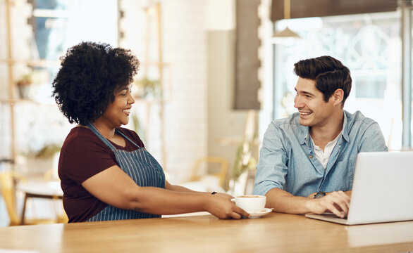 Laptop, waitress and mug with people in coffee shop for menu discussion, option and food critic. Restaurant reviewer, hospitality and customer drink with man and woman in cafe for recommendation
