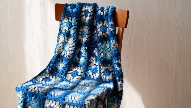 Handmade Blue Crochet Blanket on Wooden Chair