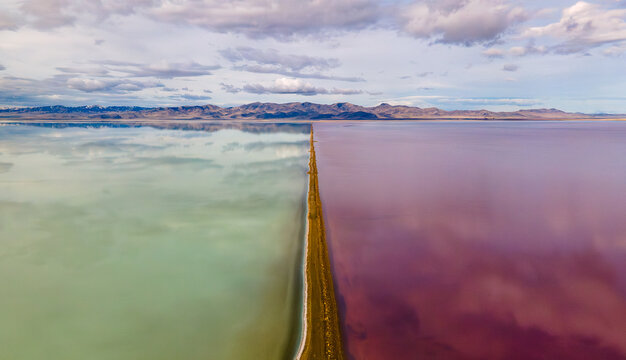 Aerial view of causeway splitting the Great Salt Lake colors
