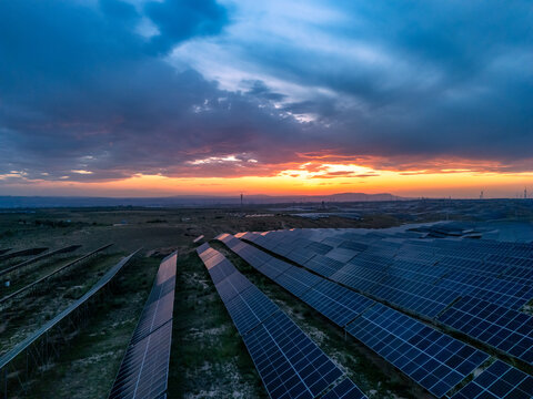 solar power plant with photovoltaic panels at sunset