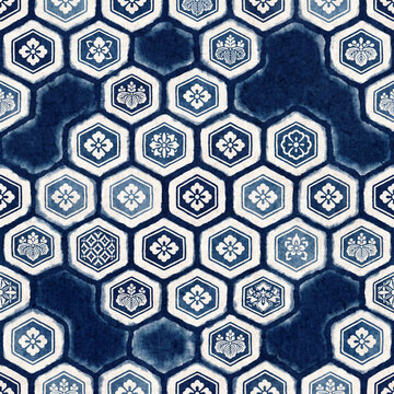 Seamless Japanese indigo shibori textile pattern featuring traditional white floral kamon crests inside geometric hexagon shapes for elegant fabric design and luxury interior wallpaper decor