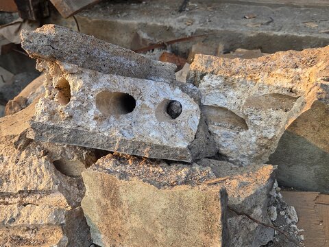 Broken concrete blocks and construction rubble on demolition site