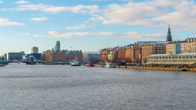 Copenhagen waterfront cityscape with historic buildings and boats on a winter day