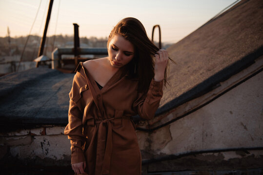 Young woman enjoying a beautiful autumn sunset on a rooftop