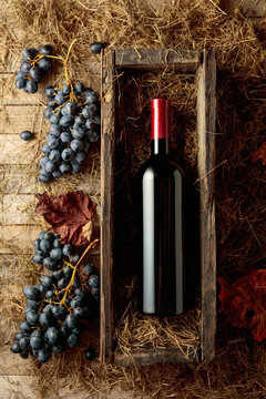 Bottle of red wine in an antique wooden box.