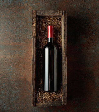 Bottle of red wine in an antique wooden box.