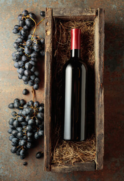 Bottle of red wine in an antique wooden box.