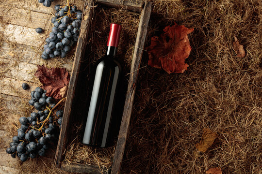 Bottle of red wine in an antique wooden box.