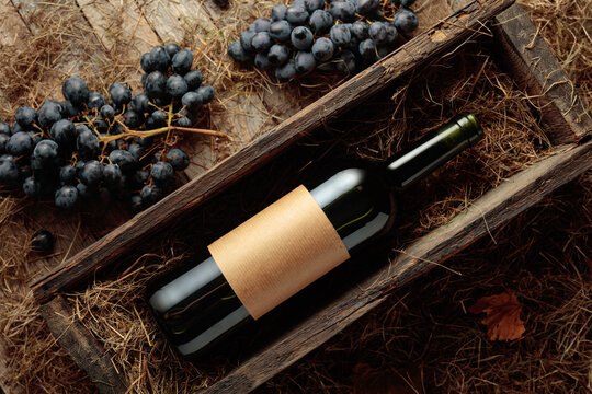Bottle of red wine in an antique wooden box.
