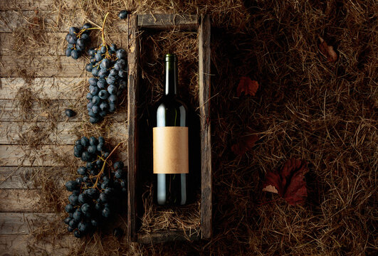 Bottle of red wine in an antique wooden box.