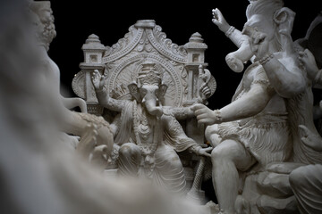 Fototapeta premium White Ganesha idol surrounded by other sculptures during a Hindu festival in India