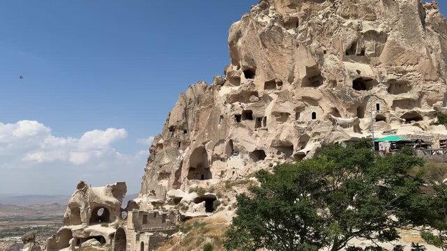 Uchisar Castle and cave dwellings in tuff rocks in Cappadocia, Turkey.