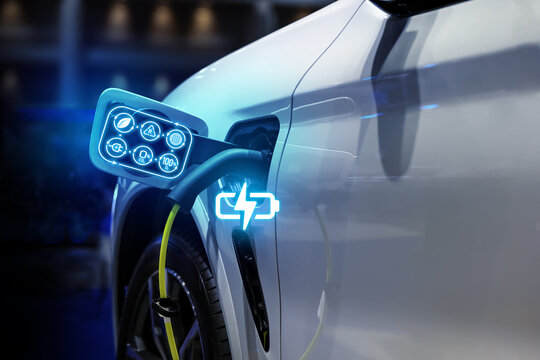 Power cable pump plug in charging power to electric vehicle EV car.