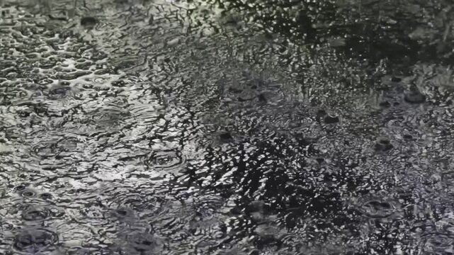 Heavy rain falling at night and soaking the ground