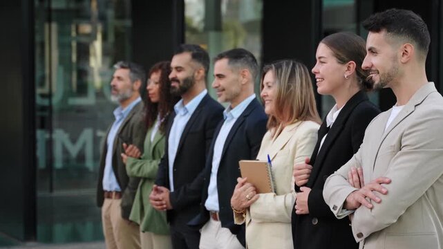 Business people standing in line and looking with confidence and determination. Diverse group of professional men and women