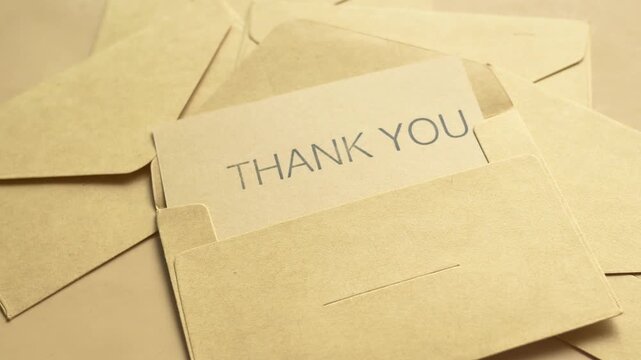 Gentle motion of thank you card in kraft envelope for gratitude and appreciation