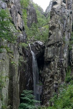 Lysefjord waterfall flowing through steep granite cliffs in Norway