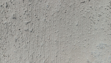 Fototapeta premium Close Up Dry Grey Dirt Ground with Fine Sand and Small Stones Texture Background