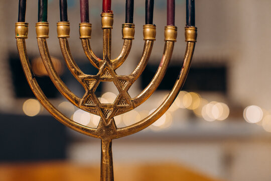 Golden menorah with star of david celebrating hanukkah