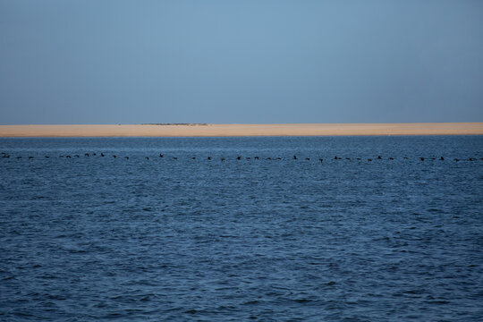 Pelican Point sand spit on the ocean horizon. Namibia