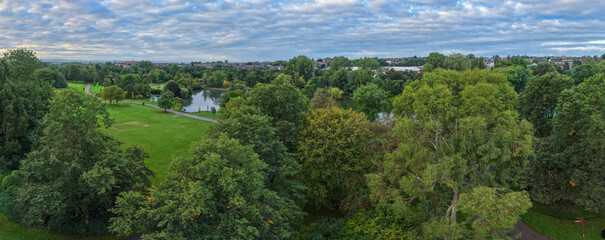 Obraz premium Panorama of Alexandra Park Woodland Canopy Boating Lake and Lawns in Oldham, Greater Manchester. 