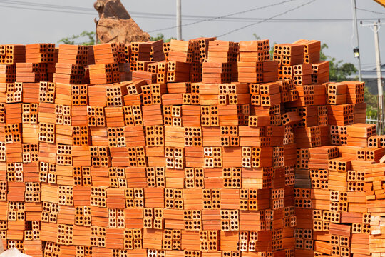 Red brick masonry walls under construction showing bonding patterns and mortar joints