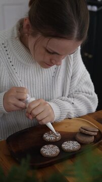 Decorating Gingerbread Cookies with Snowflake Icing, Christmas Vertical UGC