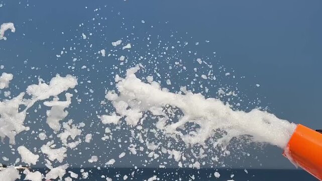 Foam Cannon Spraying White Foam at Beach