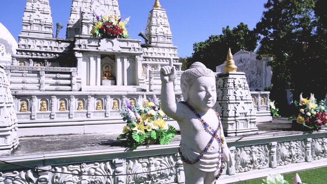 AYUTTHAYA, THAILAND - SEPTEMBER 12, 2026: Sacred Buddhist architecture features a white stupa pagoda and revered monk wax statues inside temple grounds at Ayutthaya province.