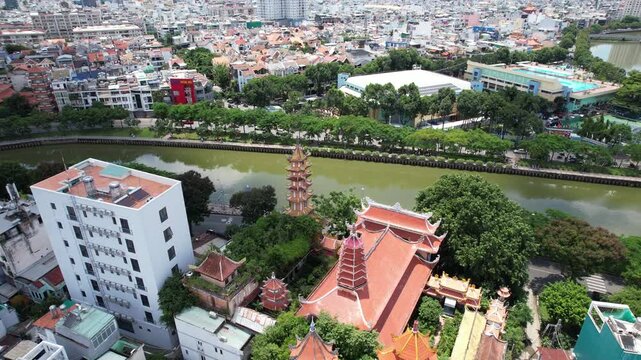 4k Aerial Drone shot of a beautiful pagoda a Buddhist temple in Ho Chi Minh city next to a river canal in Vietnam