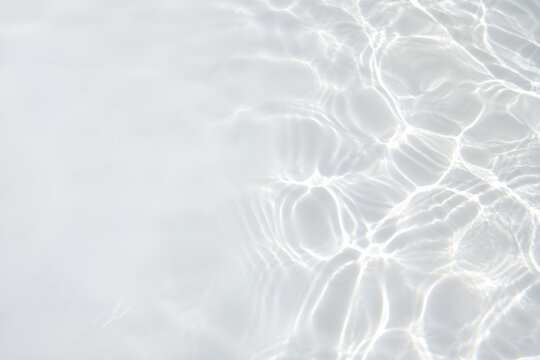 Soft sunlight caustics on white pool plaster