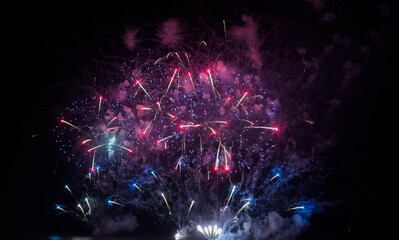 Naklejka premium Colorful fireworks over cityscape at new year night