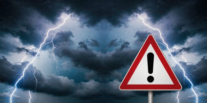 Warning sign against a dramatic stormy sky