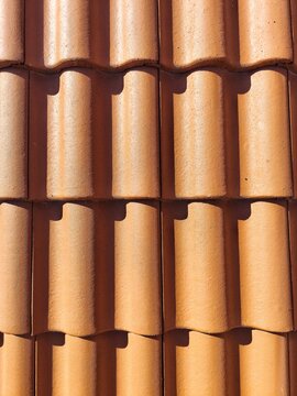 Full frame shot of traditional Mediterranean terracotta roof tiles with strong contrast
