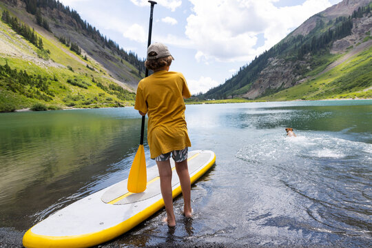 rear view of boy and his stand up paddle board, Crested Butte, Colorado
