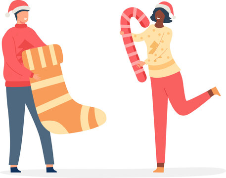 Diverse people smiling, holding a large Christmas stocking and a candy cane