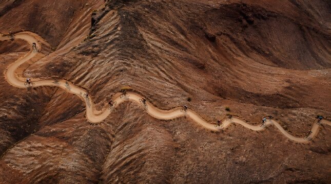 Aerial view of mountain bikers on a winding desert trail
