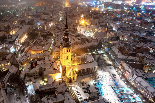 Aerial night View of Tallinn in winter, roofs are covered with snow, Christmas mood