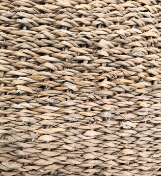 Woven seagrass basket texture background, natural braided straw fibers pattern close-up