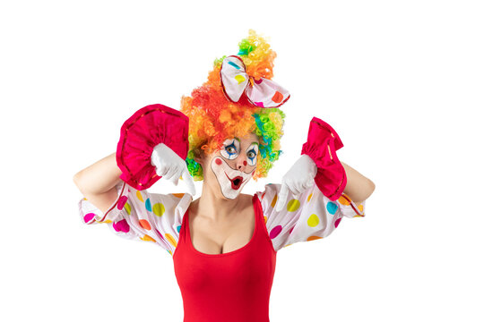 Surprised female clown pointing down at blank template copy spase for advertising, posters, greetings, invitations. Entertainer as Joker in a suit and wig, with clown whiteface makeup