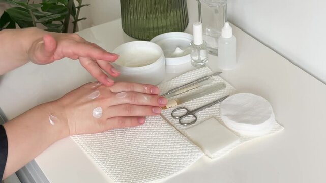 Unrecognizable Woman Doing a Manicure at Home and Applying Hand Cream