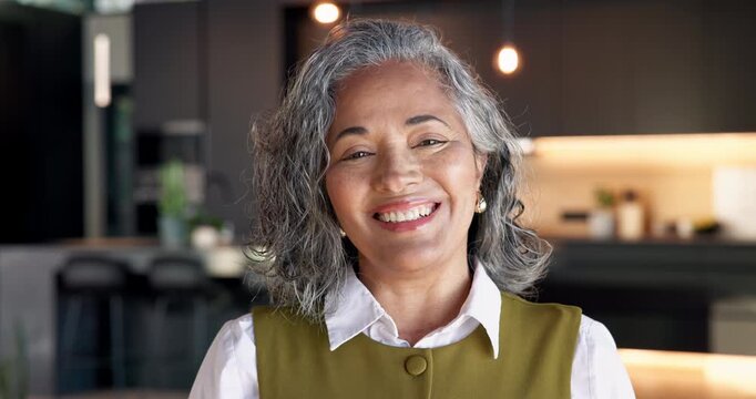 Realtor, woman and happy at open house with face, property staging and sale management expertise. Real estate, mature person or laugh for hosting showcase, new listing or home tour for resale auction