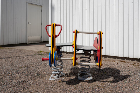 Colorful spring rider playground equipment for children in outdoor play area