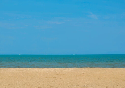 Empty Tropical Beach and Calm Blue Sea Under a Clear Sky