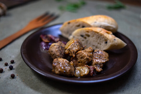 Beef stew with carrots and herbs in baking dish, traditional homemade dinner