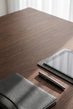Minimalist executive desk with leather portfolio and pen for corporate annual report cover and investment prospectus