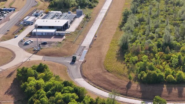 Car Driving on a Paved Track at a Testing Facility